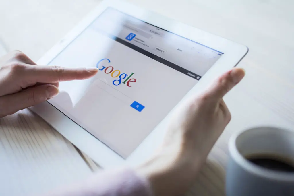 Person beginning a Google search for an appraiser on their tablet