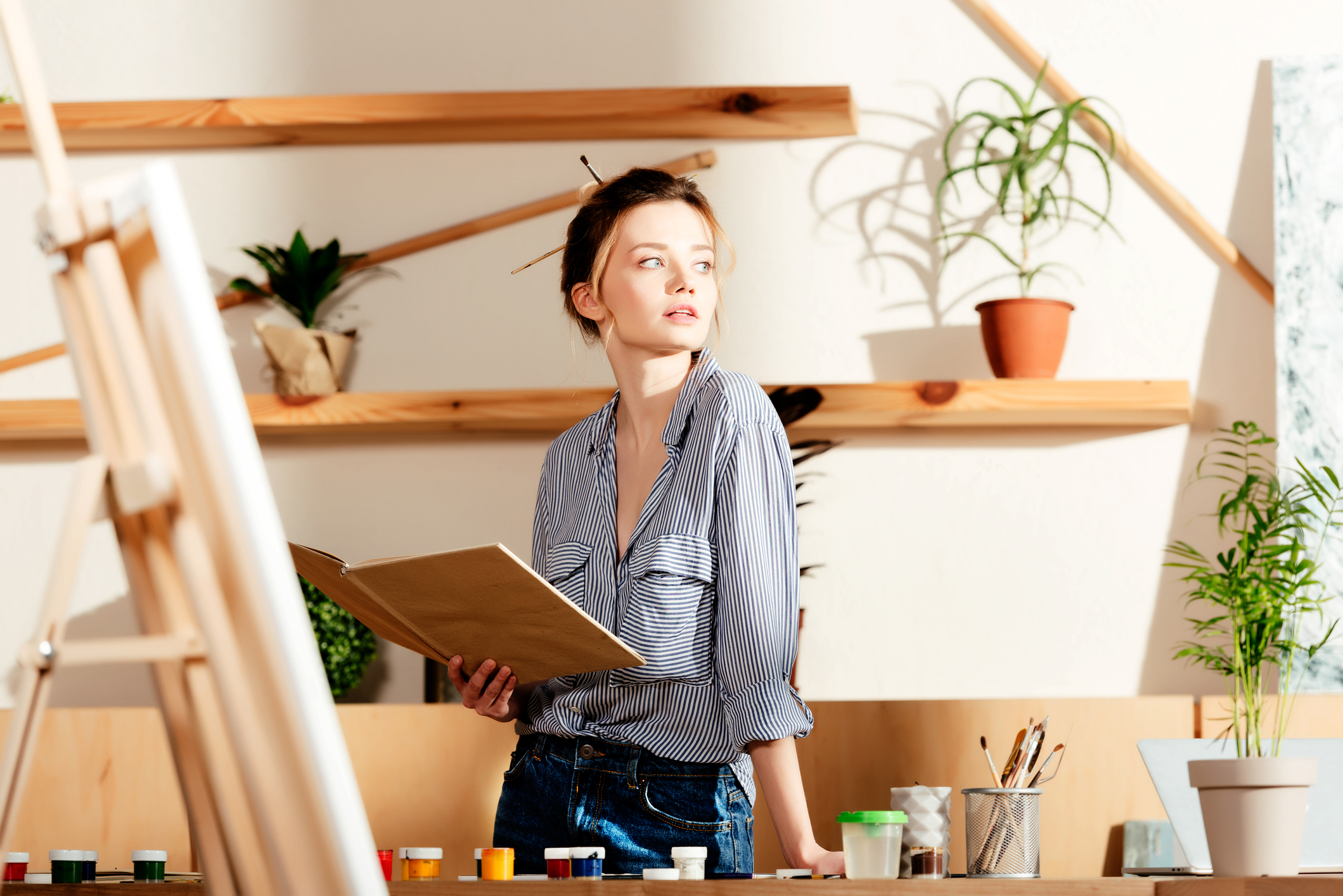 A woman reading an art book, representing art education and terminology learning