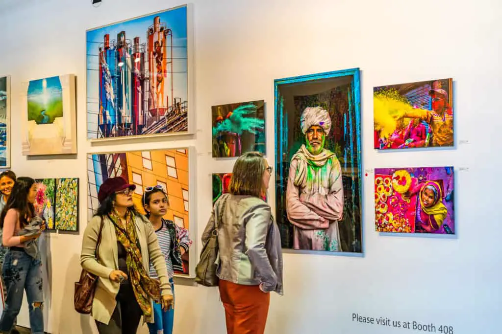 Woman viewing the work of an emerging artist at an art show in New York.