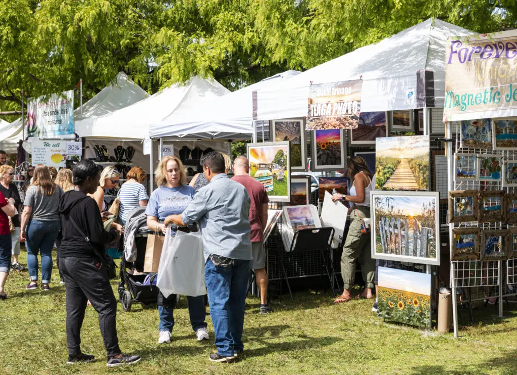 People buying art at an art fair