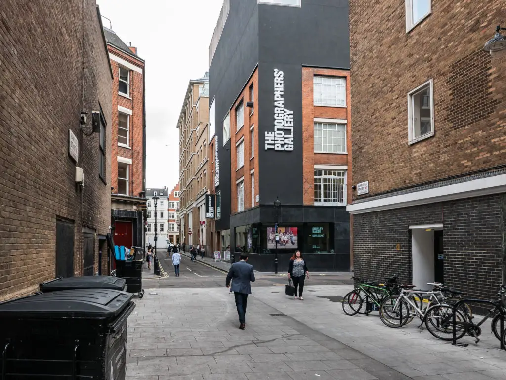 People walking down the street in front of The Photographer's Gallery in London