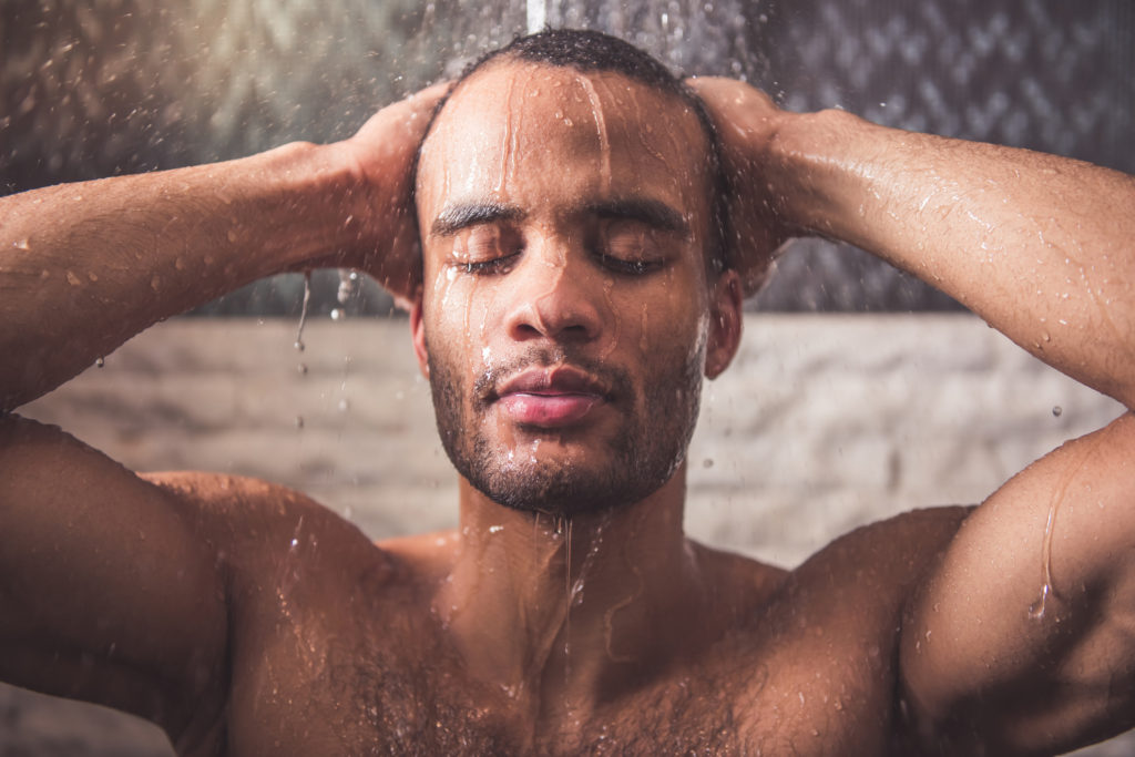Man taking a warm shower to encourage creativity.
