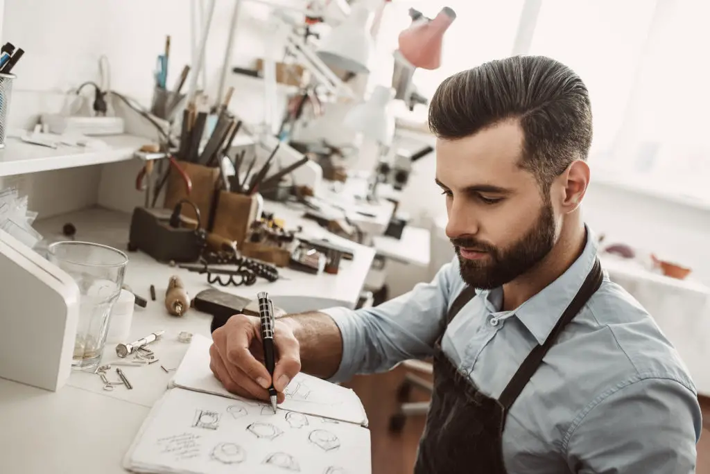 Man sketching in a notebook.