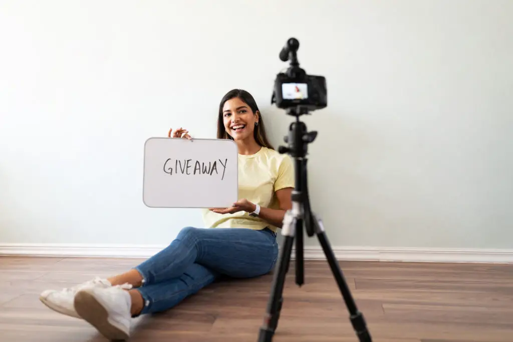 Female influencer in front of camera announcing a giveaway.