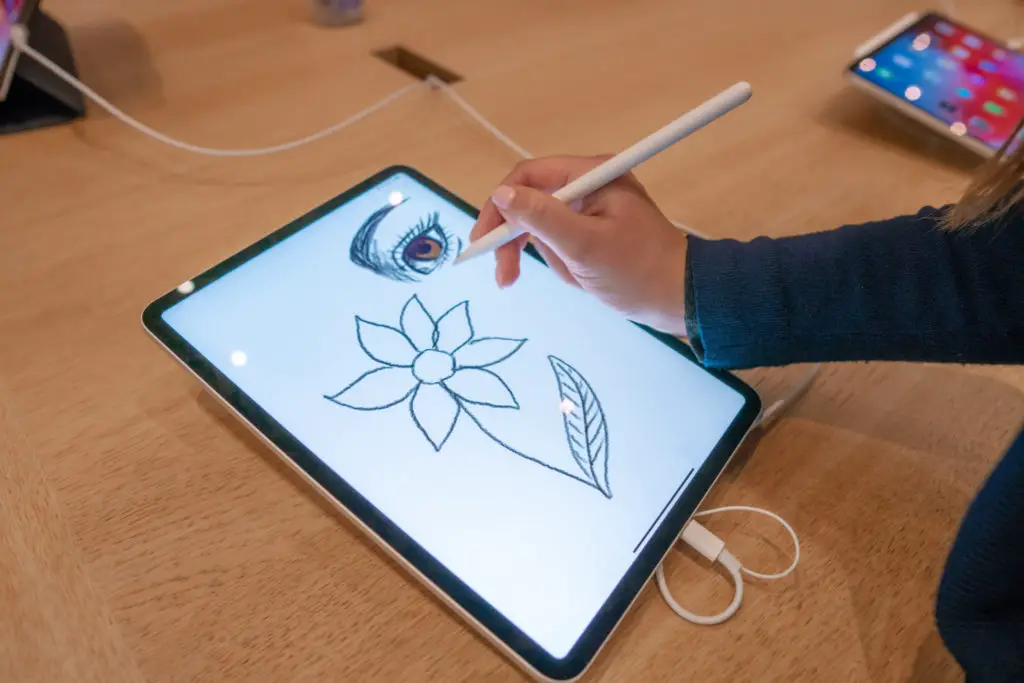 Digital artist sketching on a tablet.