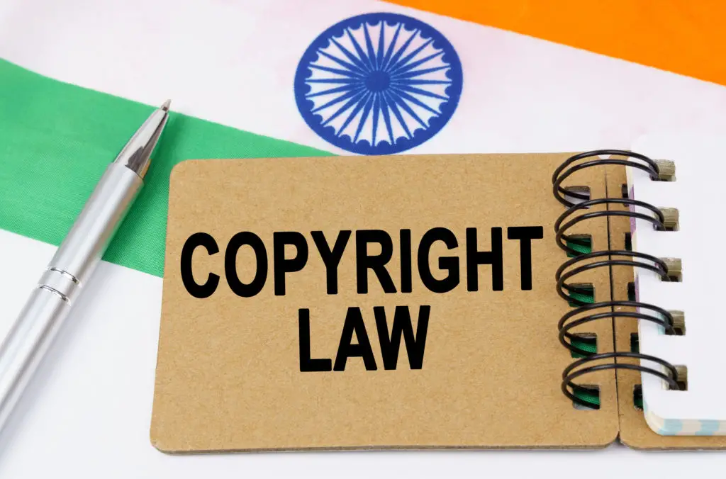 Flag of India with a pen and a book of copyright law.